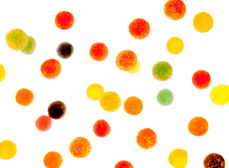 many coloured fruit gums floating in space with focus  on sweets in forground and sweets in background out of focusの写真素材
