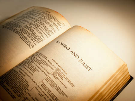 an old copy of the complete works of Shakespeare open at the first page of Romeo and Juliet  Focus on the title   yellow ageing of page edges clearly visible   Vignetting added の写真素材
