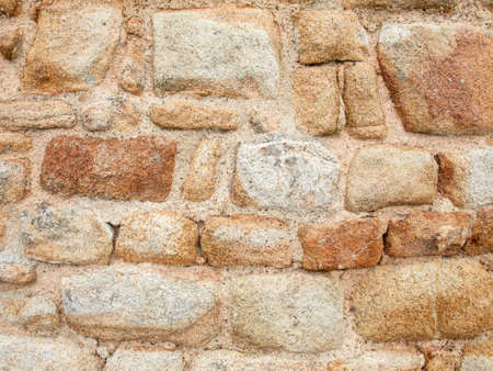 aged and weathered old red sandstone wall