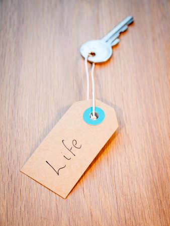 old key on a string with retro brown paper tag reading life  Secret to life  concept の写真素材
