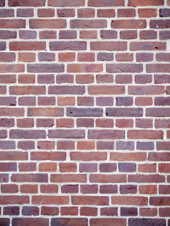detail of brick wall with red-purple bricks and white mortarの写真素材