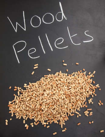 pile of wood pellets on  a blackboard with the words wood pellets written in white chalkの写真素材