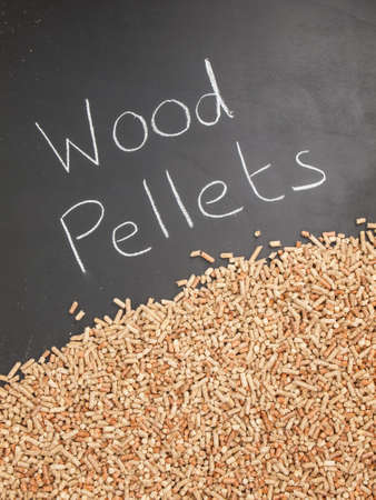 wood pellets on  a blackboard with the words wood pellets written in white chalkの写真素材