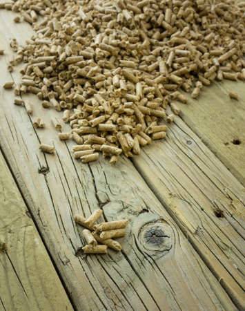 wood pellets against an aged knotted wooden backround