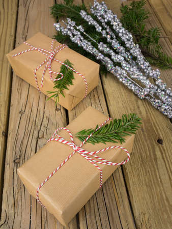 parcels wrapped in  brown paper with red and white string against an aged wooden background with...