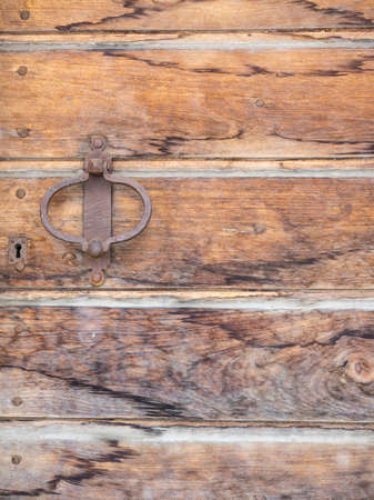 detail of aged wooden door with iron handle and lockの写真素材