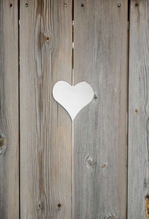heart motif in grey aged wooden shutterboard fenceの写真素材