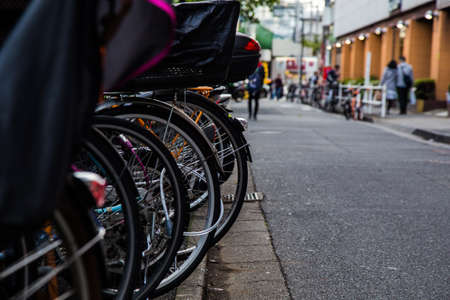 bicycles parked in a row on a side street in Shinjuku, Tokyo, Japanの写真素材