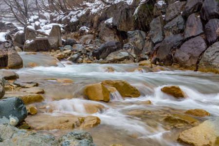 The Yokoku River flows through mountain rocks.  The river is fed by hot springs throughout the...