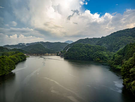 A reservoir behind a small dam in Kyushu, as seen from the highway between Fukuoka and Nagasaki, Japanの写真素材