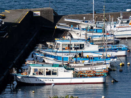 A row of fishing boats in Katase Fishing Harbor in Fujisawa, Japan. The names of each boat is written in Japanese characters on their sides.のeditorial素材