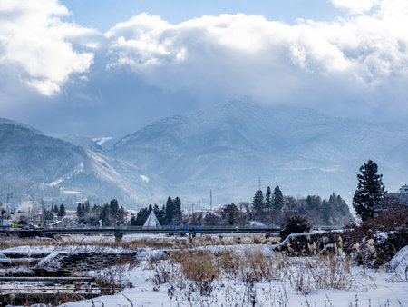 The mountains of the Japanese alps as seen from the Yomase River in Yamanouchi, Nagano Prefecture,...