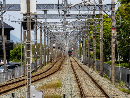 The local Nishitetsu commuter train for Yanagawa arrives at the Omizo Station platform in Okimachi,...