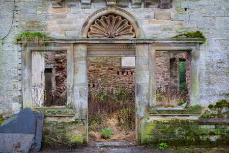 Doorway to a derelict stone mansion.の写真素材