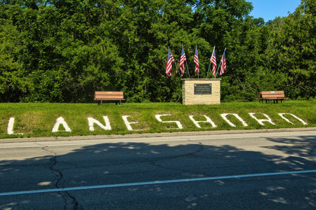 Sunny Summer day landscape of Lanesboro spelled out on a grassy slope beside American flags along the main road through Lanesboro, Minnesota.のeditorial素材
