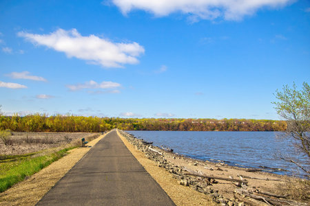 Sunny Spring landscape view of the Mississippi River Greenway Trail crossing a levee near Hastings, Minnesota.の写真素材