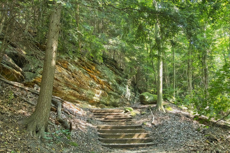 Summer shot of wide stone steps amid rock walls along a hiking trail in the forest at Cuyahoga Valley National Park, near Cleveland, Ohio.の写真素材