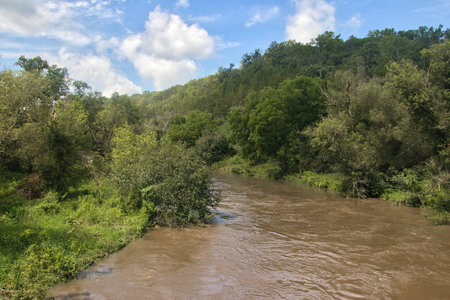 A view of the overflowing Root River after heavy rains on a sunny Summer day near Preston, Minnesota.の写真素材