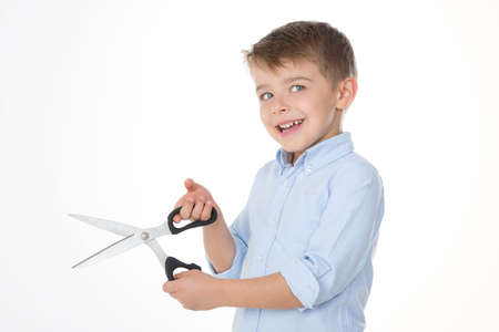 creative child holds shears in his handsの写真素材