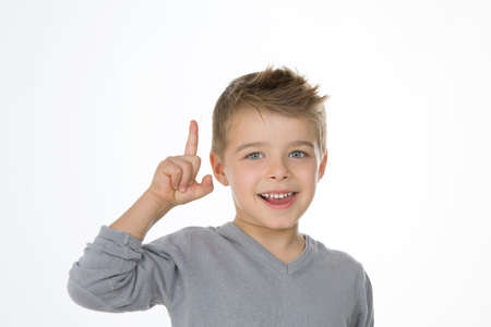 young child exults with his finger upの写真素材