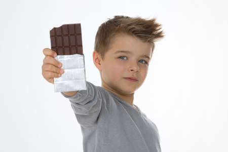 little boy shows his favourite chocolate barの写真素材