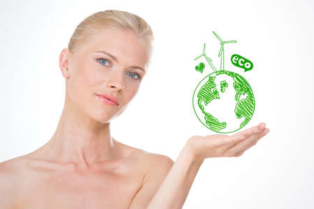 blond woman on closeup with green planet on her handの写真素材