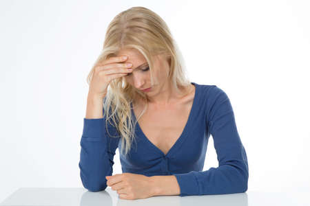 beautiful girl exhausted and worried sustain her headの写真素材