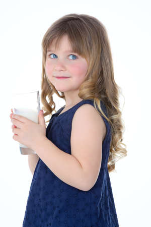girl looks at someone and drinks some fresh milkの写真素材