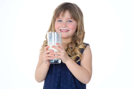 smiling child drinks milk with satisfactionの写真素材