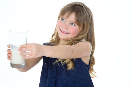 happy child gives her glass of milk to someoneの写真素材