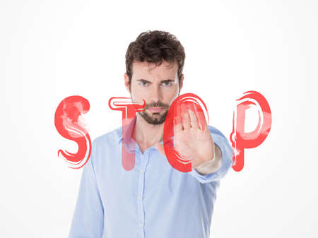 young angry guy stopping everyone with his handの写真素材