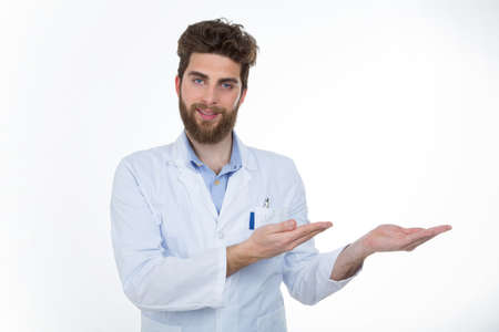 self confident practitioner at work with a lab coat standing in front of the cameraの写真素材