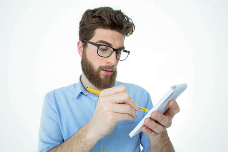 bearded man is ready to write something on his notebook