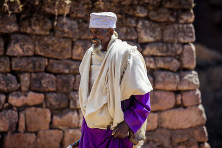 Lalibela, Ethiopia - August 20, 2020: Old Ethiopian Priest in Traditional Clothes going to the Church for prayのeditorial素材