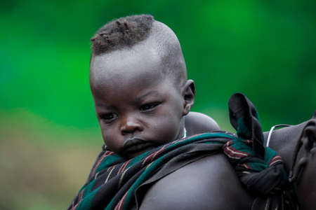 Omo River Valley, Ethiopia, November 2020, An infant with its mother in the Mursi tribeのeditorial素材