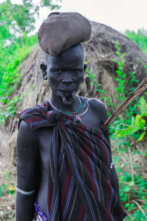Omo River Valley, Ethiopia - November 29, 2020: Portrait of Old African Woman with a big hole...