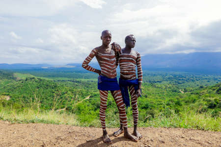 Omo River Valley, Ethiopia, November 2020, Two men in traditional paint and outfits from the local tribeのeditorial素材