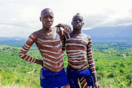 Omo River Valley, Ethiopia, November 2020, Two men in traditional paint and outfits from the local tribeのeditorial素材