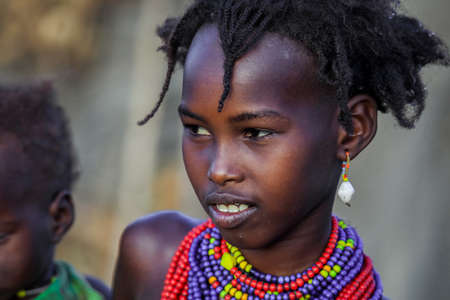 Omo River Valley, Ethiopian -November 30, 2020: Close up portraits of Dassanech Tribe Children with Traditional Bright Necklace in the Local Villageのeditorial素材