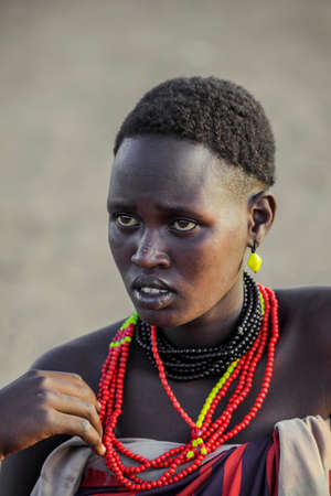 Omo River Valley, Ethiopian -November 30, 2020: Close up Portrait of Dassanech Tribe Woman with Traditional Bright Necklace and Hairstyleのeditorial素材