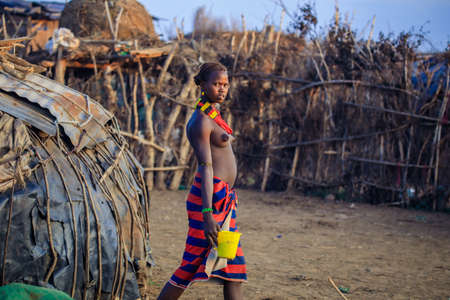 Omo River Valley, Ethiopian -November 30, 2020: Dassanech Tribe Woman with Traditional Bright...