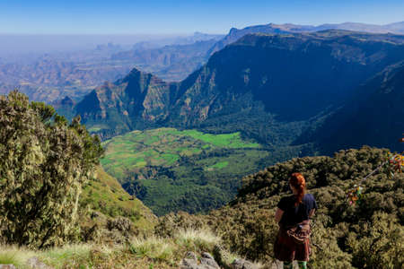White Woman Tourist looking at the Green Valley of Simien Mountains near Gondar, Northern Ethiopiaの写真素材