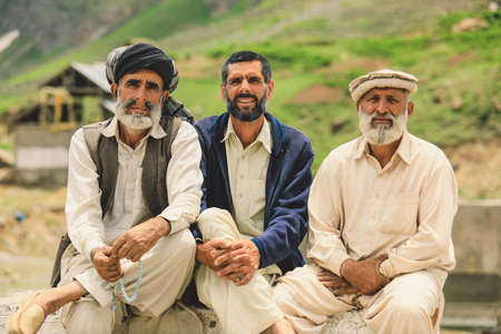Gilgit, Pakistan - June 09, 2018: Group of an Pakistani Men in Traditional Pakol smiling and posing for the Pictureのeditorial素材
