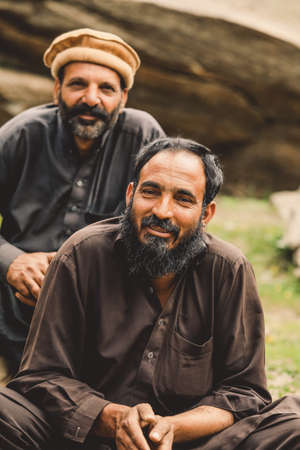 Gilgit, Pakistan - June 09, 2018: Group of an Pakistani Men in Traditional Pakol smiling and posing for the Pictureのeditorial素材