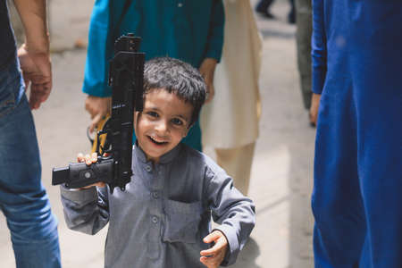 Peshawar, Pakistan - June 09, 2018: Happy and Joyful Pakistani Children playing with Toy Guns in Traditional Dressのeditorial素材