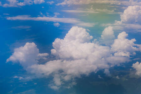 Aerial View to the Bright and Colorful Clouds under Dubai city from the Airplane Window, United Arab...
