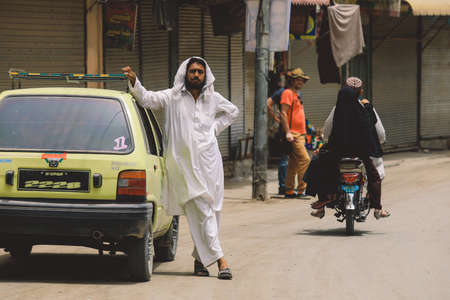 Peshawar, Pakistan - July 21, 2021: Local People on the Peshawar City Center Crowded Streetsのeditorial素材