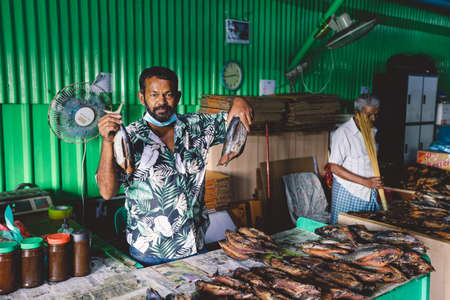 Male, Maldives - June 25, 2021: Local Seller of Dried Fish on the Central Maldivian Market of Male Cityのeditorial素材