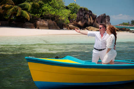 Two lovers and a boat on the paradise Seychellesの写真素材