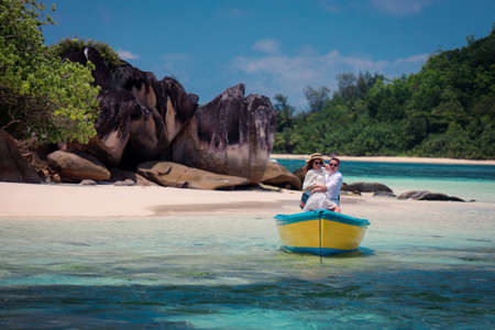 Two lovers and a boat on the paradise Seychellesの写真素材